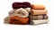 Pile of earthy colored throw rugs on white background