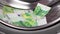 A pile of euro banknotes in the drum of a washing machine.
