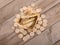 A pile of euro coins on a paper boat full of golden wheat ears