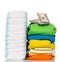 Pile fabrics, disposable diapers and money isolated on white.