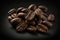 Pile of fine selected roasted coffee beans on black background