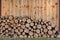 Pile of firewood neatly folded in a woodpile. Preparing fuel for the winter for the fireplace