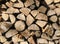 Pile of firewood. Stack of chopped tree logs nature background texture. Firewood stacked. Chipped organic firewood. Organic Backgr