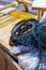 A pile of folded dark gear lying on a wooden table on a fishing boat vertical photo