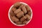 Pile of Freeze Dried Chocolate Candy Rolls Isolated on a Red Background