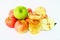 Pile of fresh apples and apple juice on white background