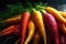 A pile of fresh carrots with green leaves on a dark background. Harvest still life. Close up.