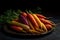 A pile of fresh carrots with green leaves on a plate. Dark background. Harvest still life.