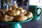 Pile of fresh croissants on green pottery cake stand