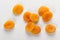 Pile of fresh dried apricots on white background, washed fruits in water , macro photo close up, top view.