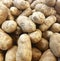 Pile of fresh from the ground raw baking potatoes. Farmers market ready to purchase produce.