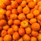 Pile of fresh organic orange Mandarines or tangerines on a market close up