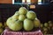 Pile of fresh tropical Asian ripe green yellow pomelos fruit from garden on table. Pomelo, pumelo, pummelo or shaddock is large,