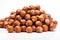 Pile of fresh and wholesome hazelnuts arranged beautifully on clean white surface