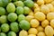 Pile of Fresh Yellow Lemons and Green Limes at Farmer\'s Market