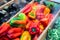 Pile of freshly harvested ripe colorful peppers on market counter