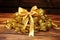 a pile of freshly polished nails tied with a golden ribbon on a wooden table