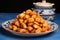 pile of fried chicken bites on a round blue ceramic plate