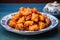 pile of fried chicken bites on a round blue ceramic plate