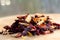 Pile of fruit tea with petals and dry fruit .The composition of the heap of tea leaves and dried hibiscus flower located on a wood