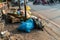 Pile of garbage bags and messy trash on street sidewalk with traffic on background in Hanoi, Vietnam