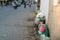 Pile of garbage bags and messy trash on street sidewalk with traffic on background in Hanoi, Vietnam