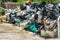 A pile of garbage behind business zone with shops and restaurants