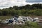 A pile of garbage in nature among the plants.Toxic plastic into nature