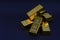 a pile of gold bar a black background. Shiny precious metals for investments or reserves.