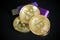 Pile of gold bitcoin cryptocurrency coins with purple digital ha