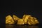 A pile of gold nuggets or gold ore on black background, precious stone or lump of golden stone, financial and business concept