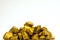 A pile of gold nuggets or gold ore on white background, precious