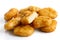 Pile of golden deep-fried battered chicken nuggets isolated on w