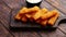 Pile of golden fried fish fingers with white garlic sauce