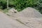 A pile of gravel and old concrete curbs piled on the side of the