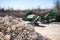 Pile of gravel-rock.Blurred on background machinery of quarry.