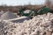 Pile of gravel-rock.Blurred on background machinery of quarry.