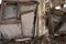 A pile of gray concrete slabs of the remains of the building in close-up against the background of the frame of the