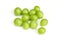 Pile of green unripe grape beans isolated on white background. Organic fruit