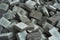 Pile of grey concrete bricks background Damp building bricks lying on construction site. Pile of grey granite pavement