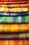 Pile of handwoven silk textiles in rainbow colors