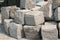 Pile of hard stone blocks of cubic form or shape and gray color