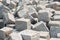 Pile of hard stone blocks of cubic form or shape and gray color