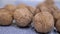 A Pile of Harvested Whole, Ripe Brown Walnuts Lies on the Table. Close-up. Zoom