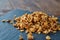 Pile of healthy granola on black stony board over vintage wooden background, top view, close-up, selective focus