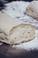 Pile of Homemade Bread Dough on a Table with a lot of Flour Around it