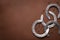 Pile of horseshoes and nails on a brown background