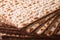 Pile of Jewish Matza Flatbread texture close-up, horizontal