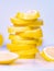 Pile of juicy lemon slices on light background, close up view. Set of cutted slices on light desk. Fruits composition on