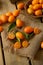 Pile of kumquat on jute canvas over the wooden table